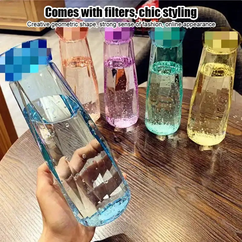 Modern blue diamond water bottle with clear geometric design and colorful filter caps for kitchen and sport travel