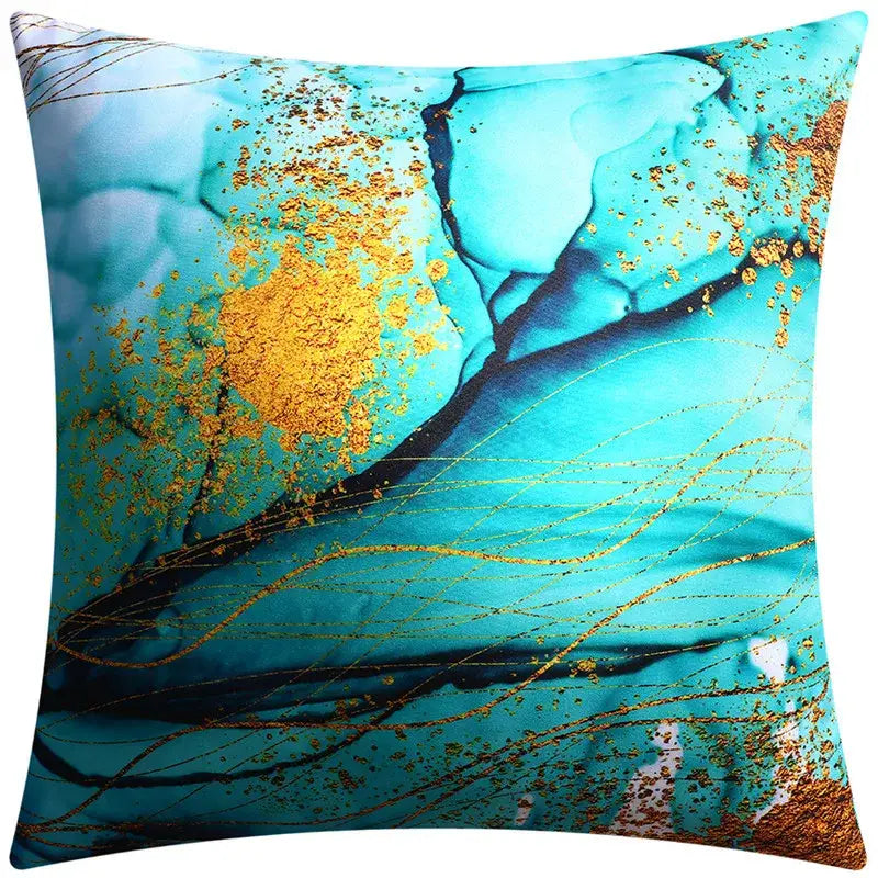 A modern blue floral cushion cover featuring a turquoise and gold abstract marbled design with flowing black lines decorbites blue floral