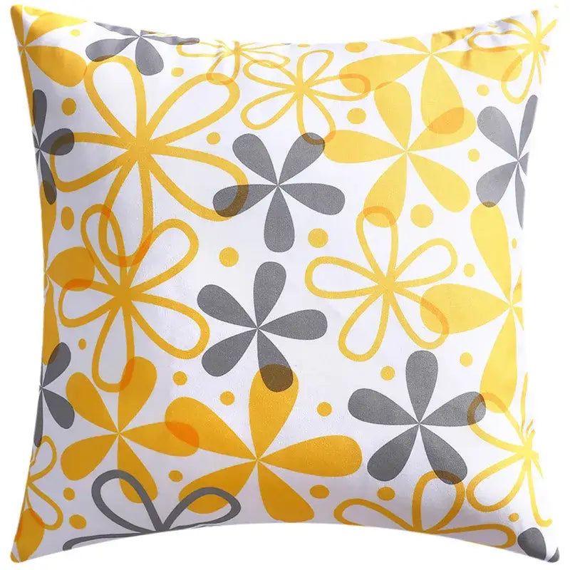 A square cushion cover with bold yellow and gray flower patterns on white background for decorbites blue floral decor