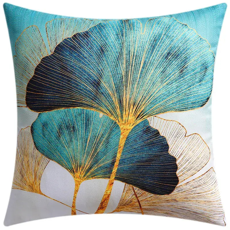 Square cushion cover featuring stylized teal and navy blue ginkgo leaves with gold outlines for modern blue floral decorbites blue floral decor