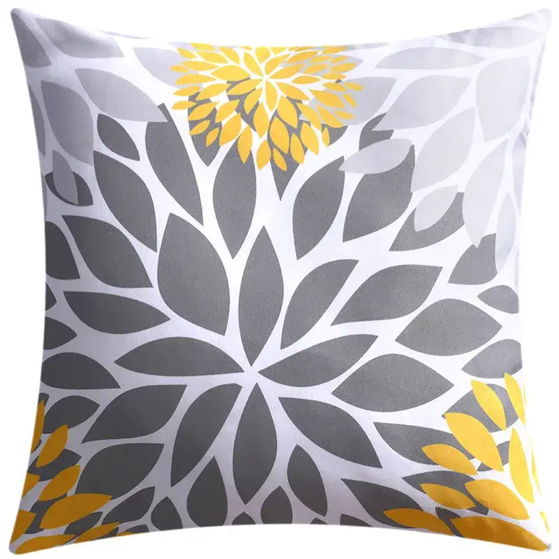 A modern blue floral cushion cover with bold yellow and gray leaf patterns on white for living room decorbites decor