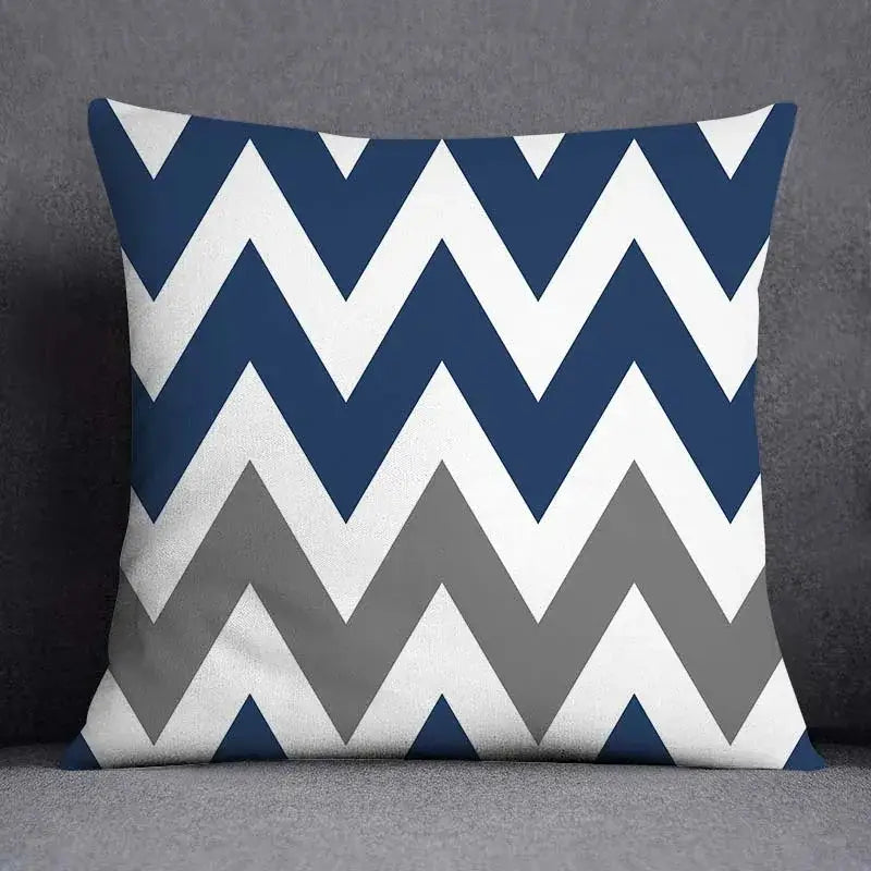 Square throw pillow with bold navy blue white and gray chevron pattern featuring geometric floral design for living room