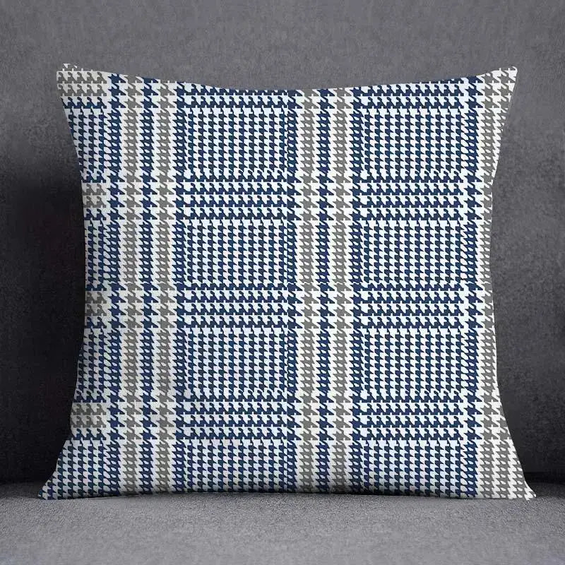 Modern blue geometric floral design square cushion with navy blue white and gray houndstooth pattern for living room