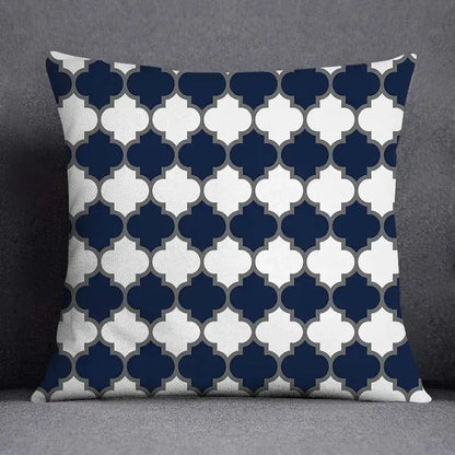 Square throw pillow with navy blue and white geometric floral design quatrefoil pattern outlined in gray for living room