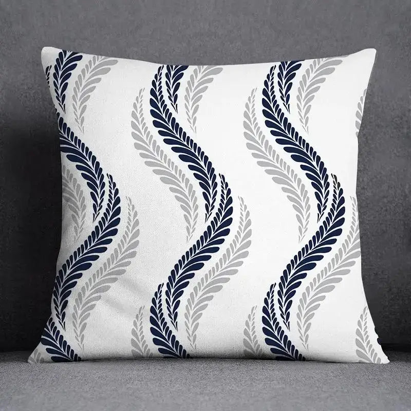 A square throw pillow with a white base and geometric floral design in navy blue and gray for living room use