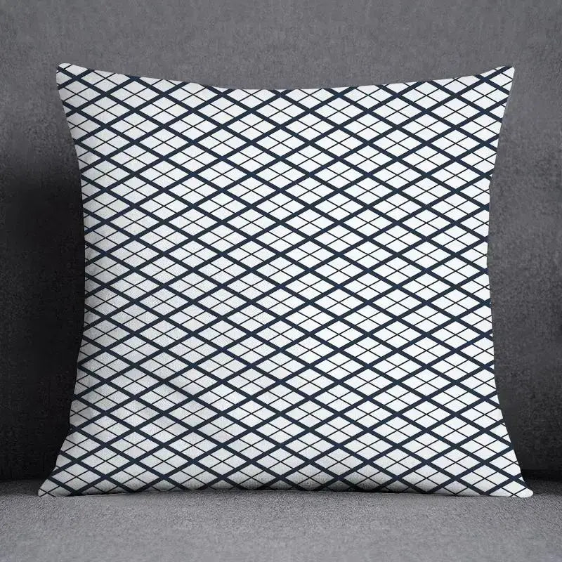 Square throw pillow with bold black and white diamond grid pattern featuring a modern geometric floral design for living room use