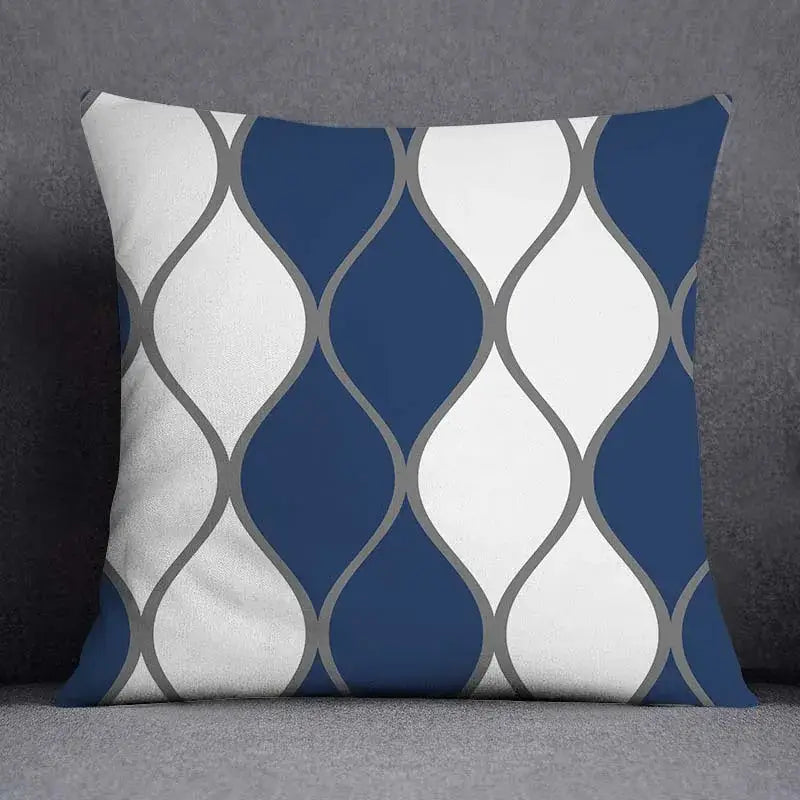 A square throw pillow with a modern blue geometric floral design in navy blue white and gray for living room use