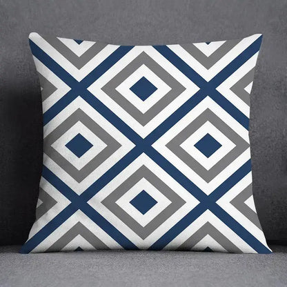 Square throw pillow with a modern blue geometric floral design featuring navy, gray, and white concentric diamonds
