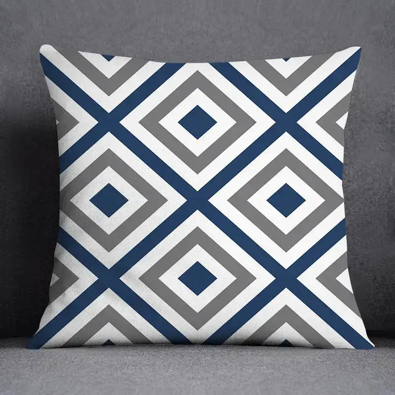 Square throw pillow with a modern blue geometric floral design featuring navy, gray, and white concentric diamonds