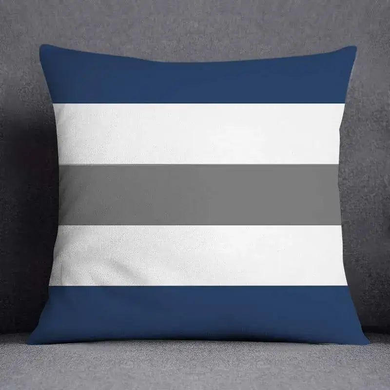 Square throw pillow with bold navy blue white and gray stripes featuring modern geometric floral design for living room