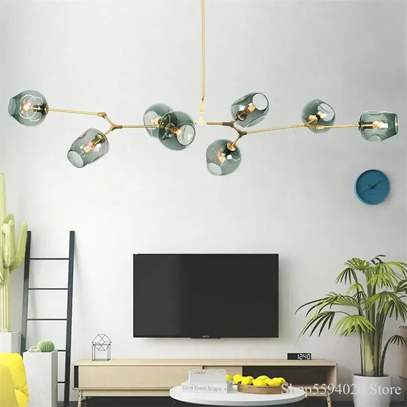 Modern blue glass black gold pendant light featuring teal glass globes in a gold-toned black gold pendant chandelier