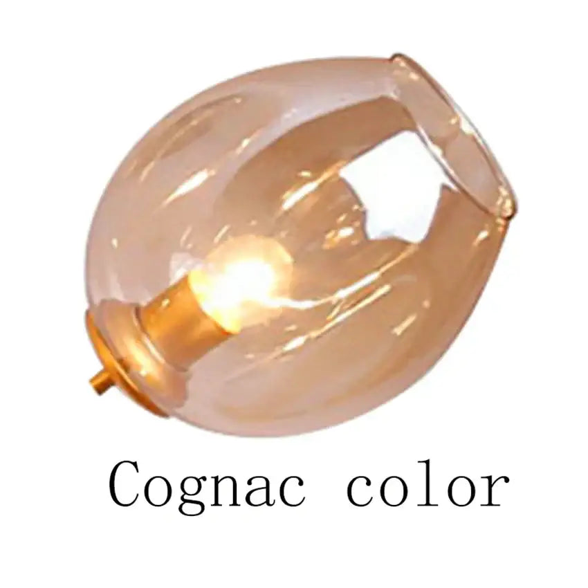 Modern blue glass black gold pendant light with cognac-colored glass lampshade featuring warm amber hue and smooth design