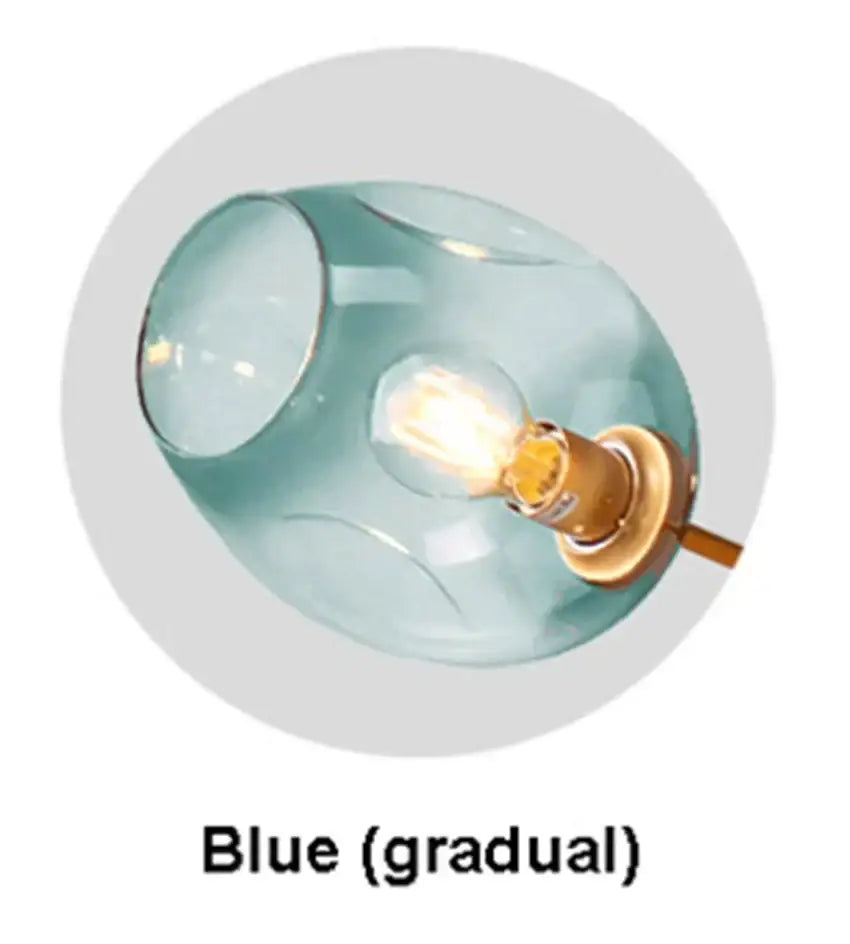 Modern blue glass black gold pendant light featuring a translucent blue gradient glass and warm black gold pendant fixture