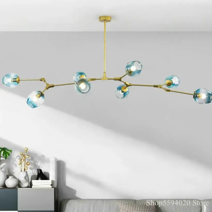 Modern brass-toned glass black gold pendant light with blue glass globes in a branching living room chandelier decorbites glass black