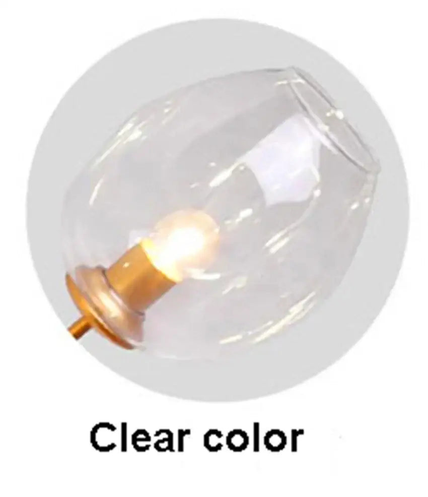 Modern blue glass black gold pendant light featuring a clear glass globe with warm-toned brass base decorbites glass black gold