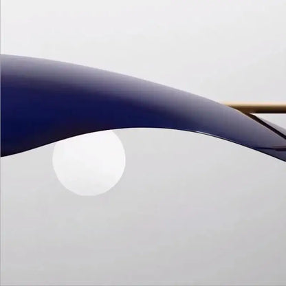 A sleek curved navy blue metal arm of a modern decorbites glass bubble chandelier dining room pendant light