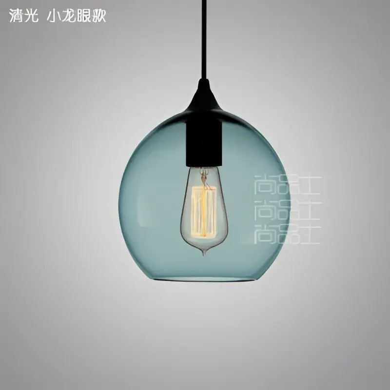 A sleek teal glass led pendant lamp with black metal fixture and exposed edison bulb for dining room lighting