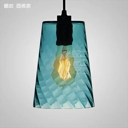 Modern blue glass led pendant lamp featuring a textured teal glass led pendant with exposed filament bulb for dining room lighting