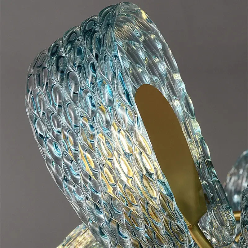 Modern blue glass led pendant lamps feature a translucent textured blue glass shade with gold-toned metallic accents