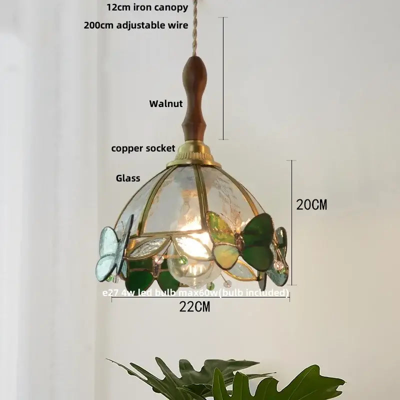 A modern butterfly glass led pendant light with walnut handle copper socket and green blue decorbites butterfly glass motifs