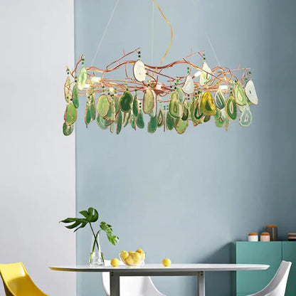 A modern copper-toned decorbites agate chandelier with green and white agate slices for colorful led lighting in dining rooms