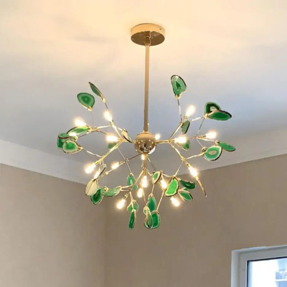 A modern decorbites agate chandelier with gold metal frame and green agate slices featuring colorful led lighting