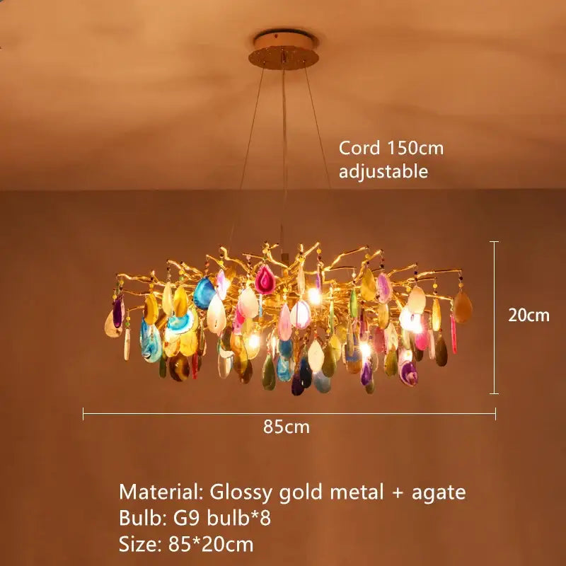 A modern decorbites agate chandelier with colorful led lighting featuring glossy gold metal arms and blue green agate slices