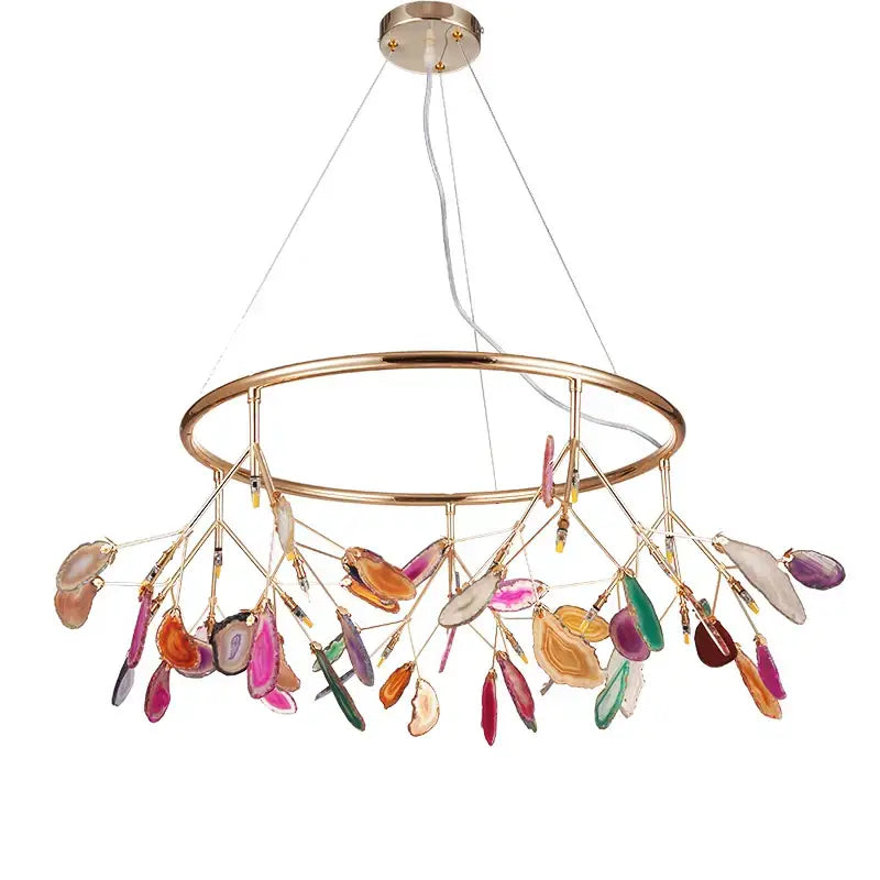 A modern decorbites agate chandelier with a brass frame and colorful led lighting in pink green and purple shades for dining room decor