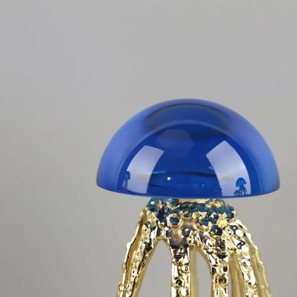 Modern blue and green crystal jellyfish sculpture with translucent blue glass and gold-toned tentacles by decorbites crystal jellyfish decor