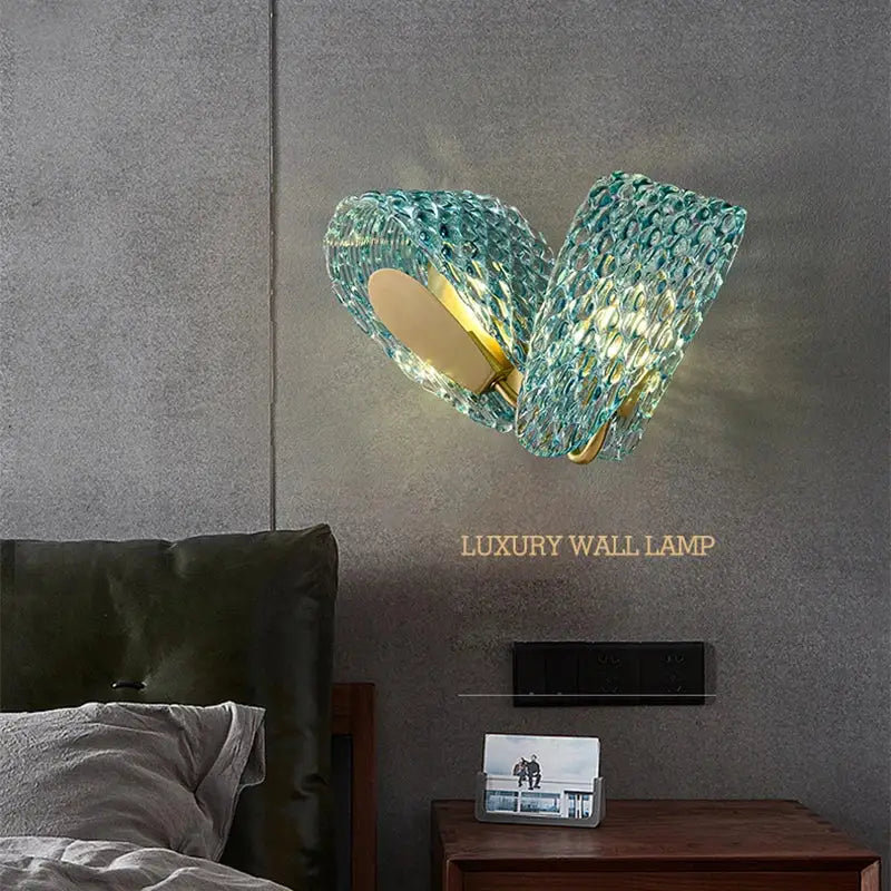 Modern blue and green decorbites glass chandelier featuring a teal textured glass wall lamp with gold metal base