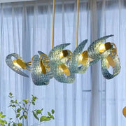Modern blue and green decorbites glass chandelier with swirling translucent shades and gold-toned metal fixtures for dining room light