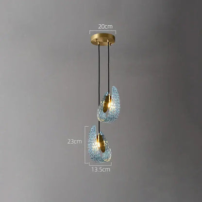 Modern blue and green decorbites glass chandelier featuring textured blue glass with gold-toned metal accents for dining rooms