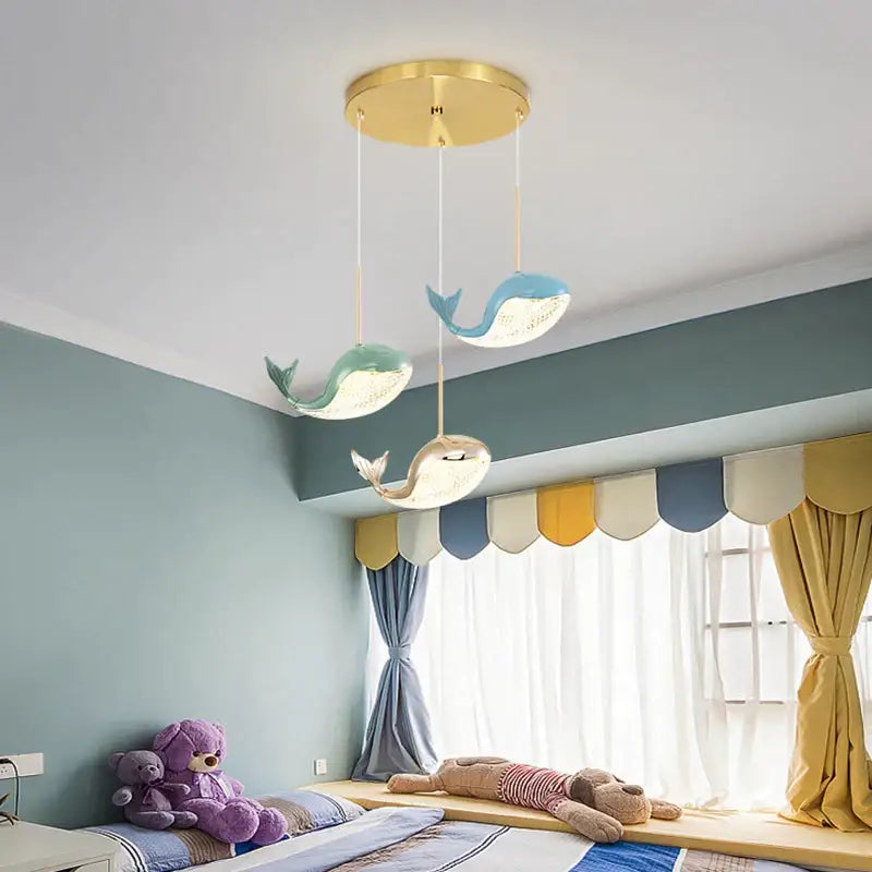 Modern blue green and gold decorbites dolphin chandelier features three whale-shaped pendant lights with underlit interiors