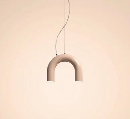 A sleek matte beige u-shaped pendant light with thin metallic cord suspension in a modern blue metal arch chandelier style