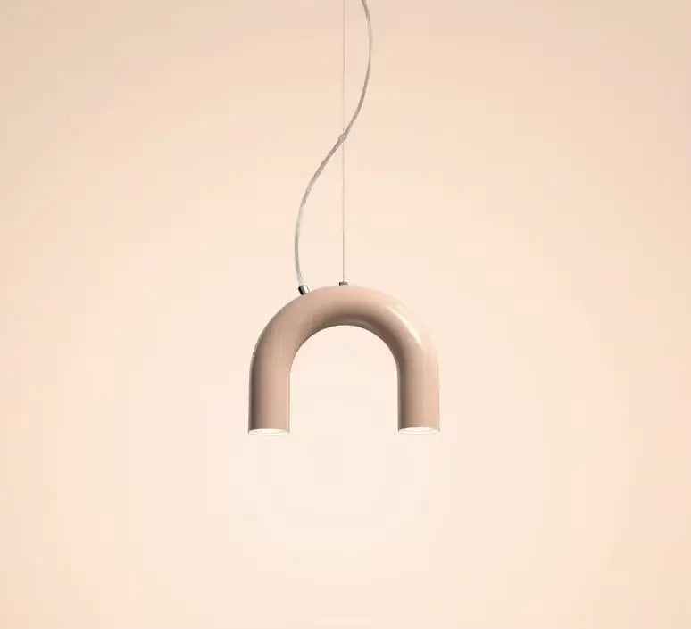 A sleek matte beige u-shaped pendant light with thin metallic cord suspension in a modern blue metal arch chandelier style