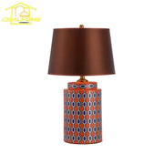 Modern blue orange ceramic table lamp with orange base geometric blue white pattern and brown satin shade for bedroom use