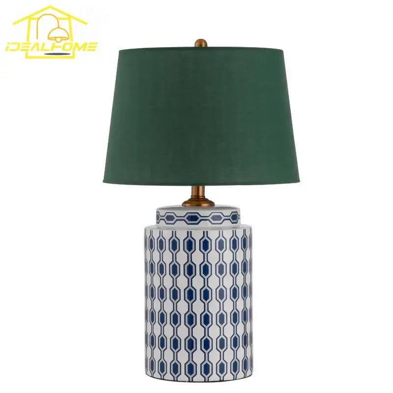 Modern blue and orange ceramic table lamp with a white base featuring blue geometric patterns and a dark green shade