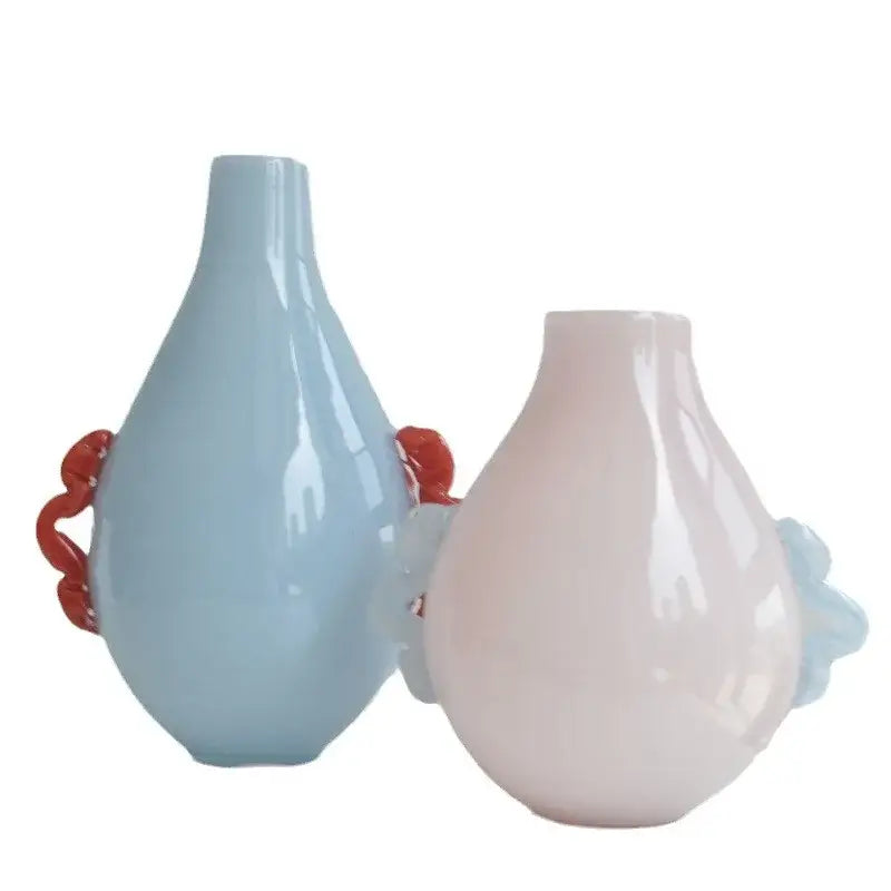 Two glossy ceramic vases with glass geometric flower handles in blue and pink for modern living room decor