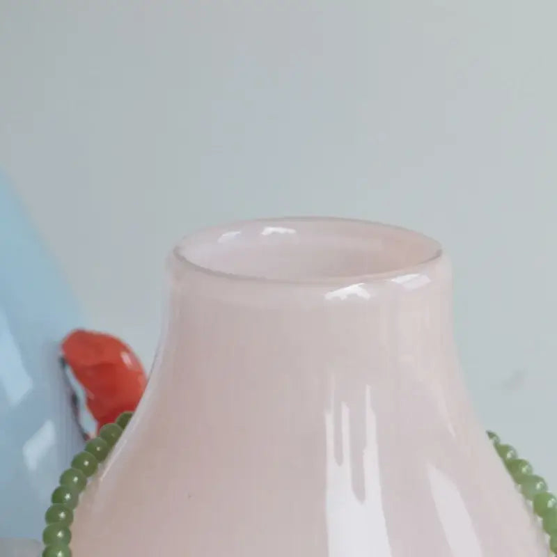 A translucent pink glass geometric flower vase with a smooth glossy finish and rounded neck for living room decor