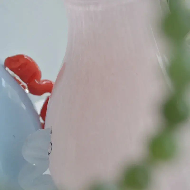 Translucent pink glass geometric flower vase with smooth rounded body and vertical ridges for living room decor