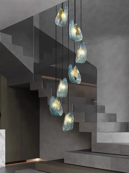 Modern blue peacock leaf glass chandelier features woven textured blue glass pendant lights in an elegant cascade for dining room decor