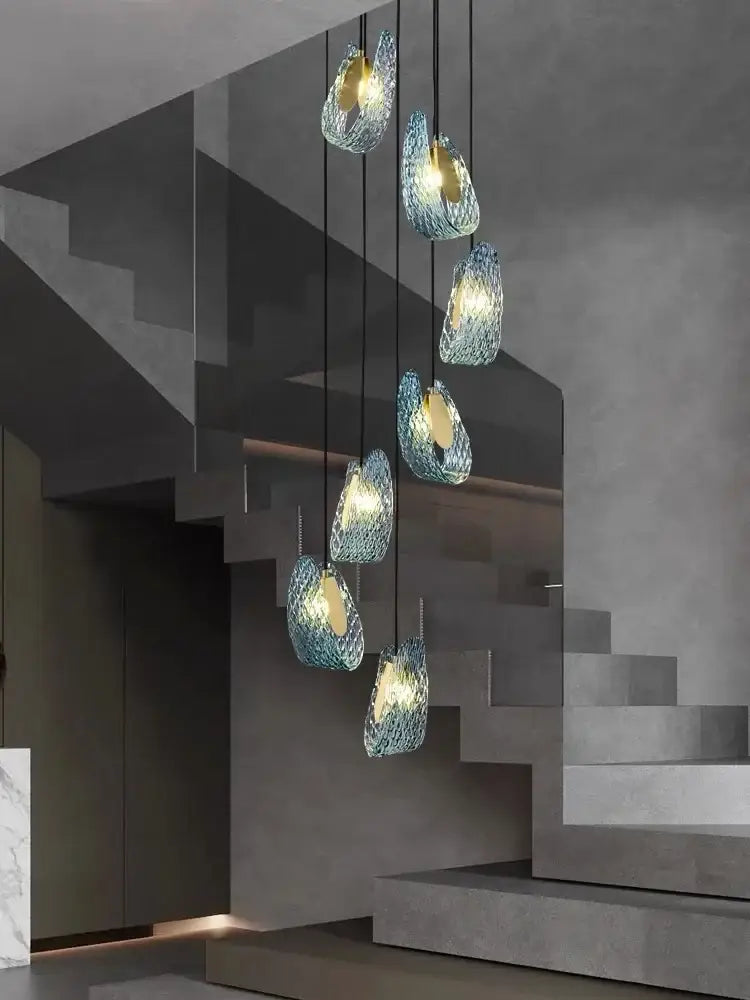 Modern blue peacock leaf glass chandelier features woven textured blue glass pendant lights in an elegant cascade for dining room decor