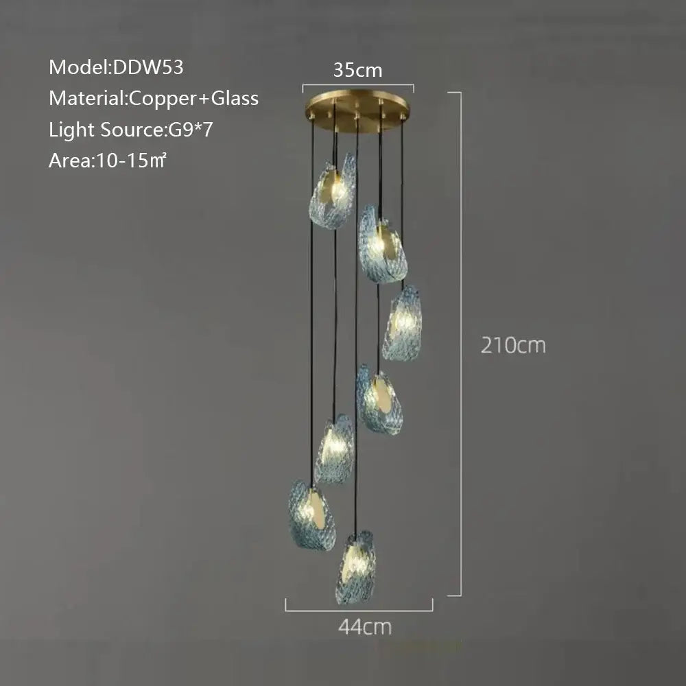 Modern blue peacock leaf glass chandelier with seven iridescent blue-green teardrop shades on brass fixture for dining room decorbites