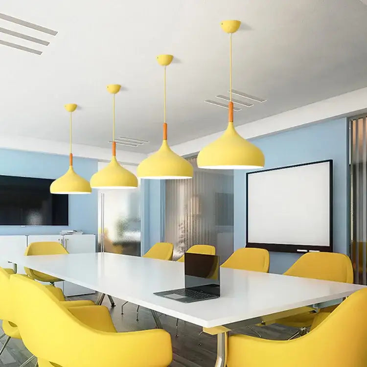 Yellow pendant lights with wood accent help create modern ambiance in kitchen with blue and pink tones
