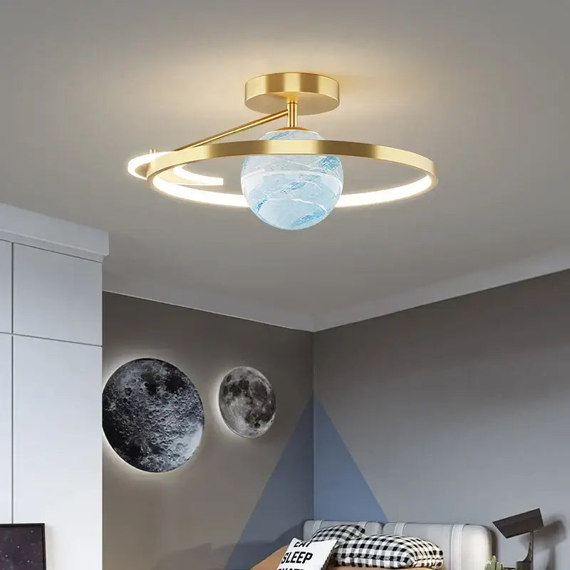 Modern blue star led pendant light featuring a gold-toned fixture with a translucent blue globe centerpiece and circular accents
