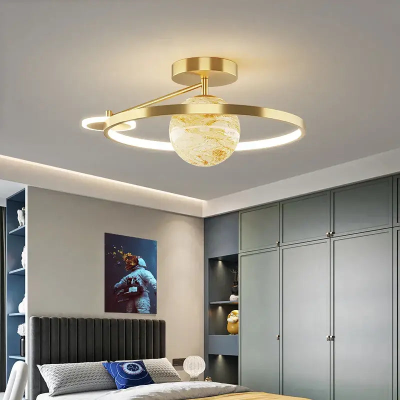 Gold-toned pendant light with textured glass globe and circular rings for decorbites blue star led bedroom fixture