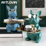 Two stylized blue and teal decorbites bulldog figurines coin bank storage trays with sunglasses and bow ties holding cosmetic items