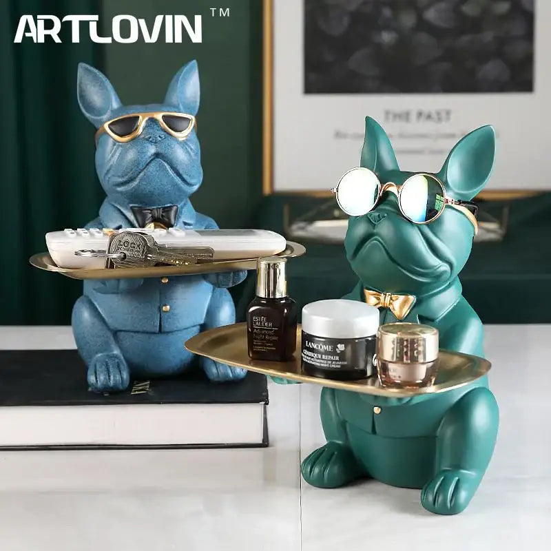 Two stylized blue and teal decorbites bulldog figurines coin bank storage trays with sunglasses and bow ties holding cosmetic items