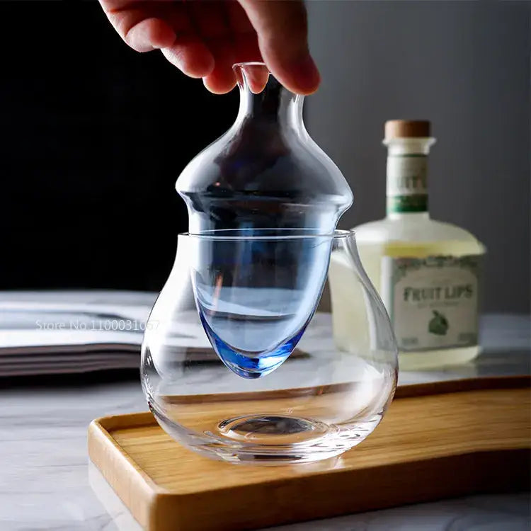 Clear glass wine pot with blue-tinted base and elegant bulbous shape as a modern wine pot ice jug