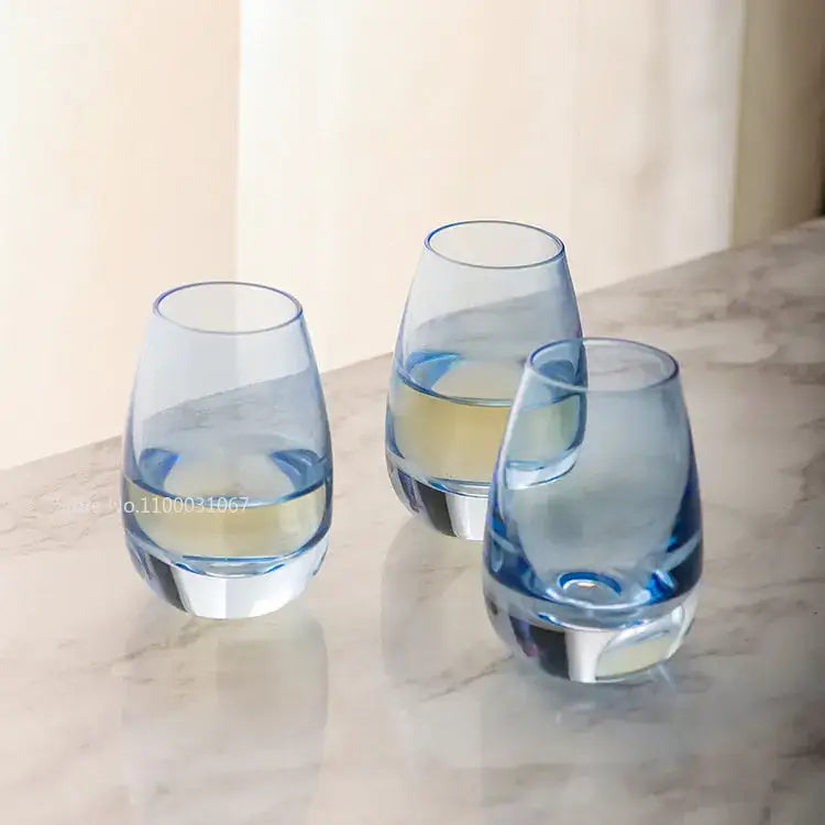 Three translucent blue glass tumblers with thick bases for modern glass wine pot ice and pot ice jug dining use